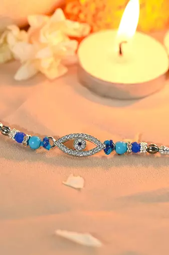 Blue thread evil eye rakhi with sparkling stones and beads