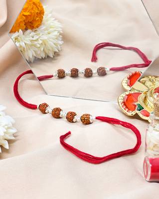 Red thread rakhi with four rudraksha beads and silver detailing 3