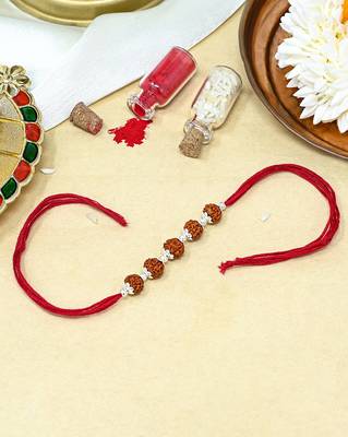 Red thread rakhi with five rudraksha beads and silver detailing 1