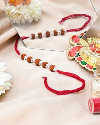 Red thread rakhi with five rudraksha beads and silver detailing 3