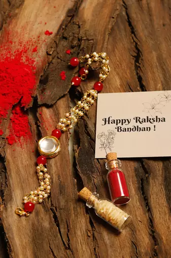 Red stone pearl kundan rakhi