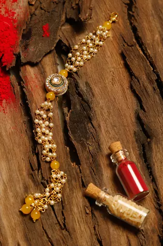 Gold and yellow beaded kundan rakhi