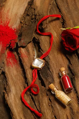 Red thread rakhi with stone