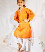 Girl's traditional raksha bandhan outfit - orange cotton kurta with white leggings set for casual festival wear