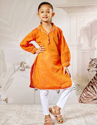 Girl's traditional raksha bandhan outfit - orange cotton kurta with white leggings set for casual festival wear 3
