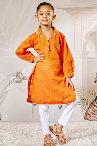 Girl's traditional raksha bandhan outfit - orange cotton kurta with white leggings set for casual festival wear