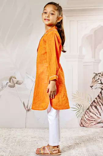 Girl's traditional raksha bandhan outfit - orange cotton kurta with white leggings set for casual festival wear