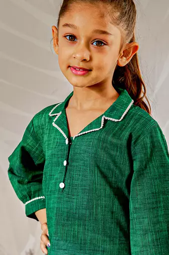 Girl's traditional raksha bandhan outfit - green cotton kurta with white leggings set for casual festival wear
