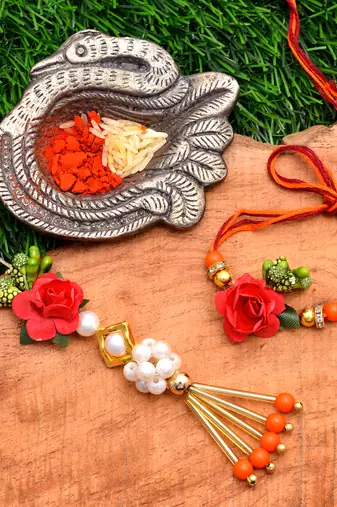 Handcrafted pearl & gold bead rakhi
