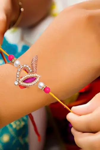 Handcrafted pearl & gold bead rakhi