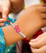 Handcrafted pearl & gold bead rakhi