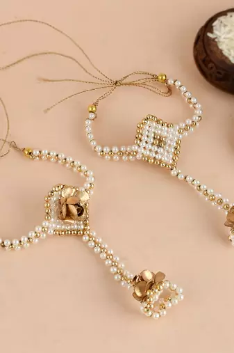 Handcrafted pearl & gold bead rakhi