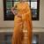 Mustard orange handwoven tissue linen saree with mirror work