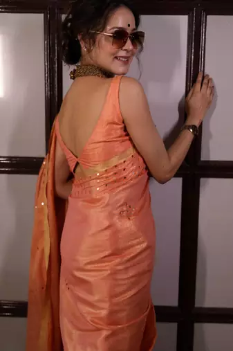 Orange handwoven tissue linen saree with mirror work