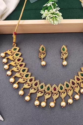 Matte gold peacock necklace set with ruby & green stones, pearl drops – ethnic bridal jewellery