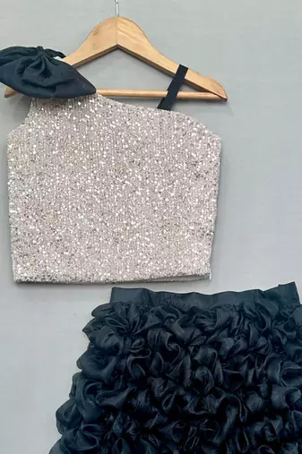 Silver sequin top with black ruffled skirt