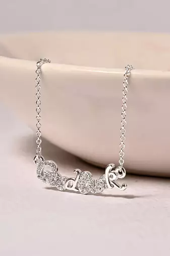 Engraved silver pendant necklace with 'good luck' inscription and sleek design