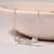 Engraved silver pendant necklace with 'good luck' inscription and sleek design