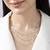 Triple layered heart charm necklace with gold chain accent and romantic touch