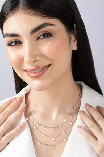 Triple layered heart charm necklace with gold chain accent and romantic touch