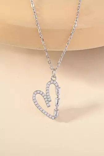 Heart-shaped cz silver pendant necklace with trailing stones and romantic vibe