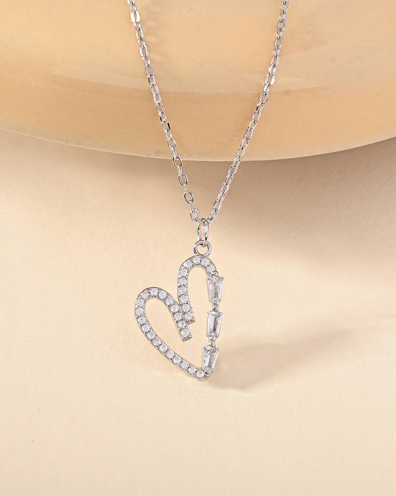 Heart-shaped cz silver pendant necklace with trailing stones and romantic vibe