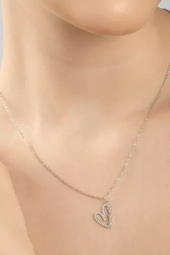 Heart-shaped cz silver pendant necklace with trailing stones and romantic vibe