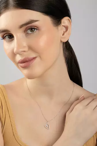 Heart-shaped cz silver pendant necklace with trailing stones and romantic vibe