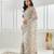 Gold floral beads and stones embellished net saree