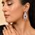 Silver-plated red stone studded drop earrings