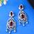 Silver-plated red stone studded drop earrings