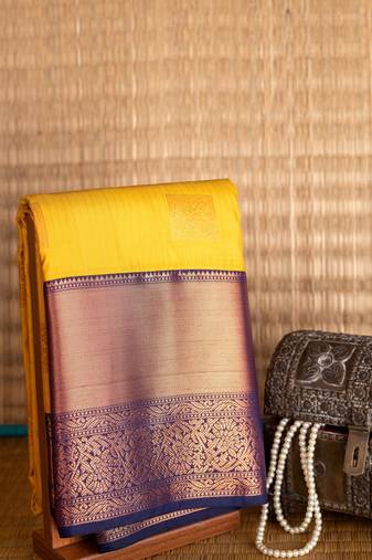 Mustard and blue turning semi silk saree