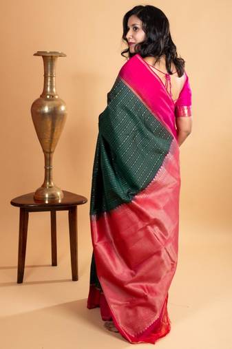 Dark green silk saree with pink border