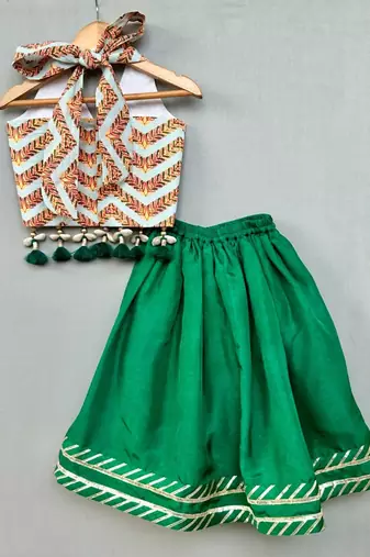 Stylish halter top with matching green lehenga for girls