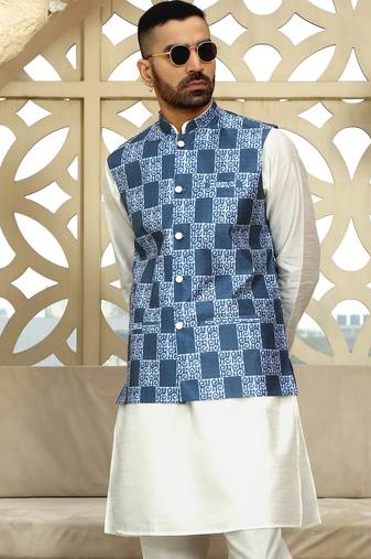 Silk blend solid cream kurta and churidar with blue printed nehru jacket