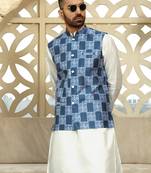 Silk blend solid cream kurta and churidar with blue printed nehru jacket