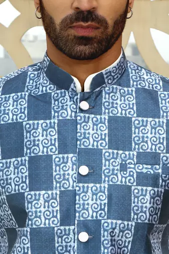 Silk blend solid cream kurta and churidar with blue printed nehru jacket
