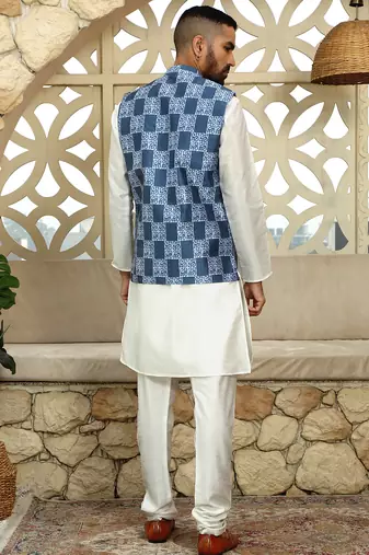 Silk blend solid cream kurta and churidar with blue printed nehru jacket