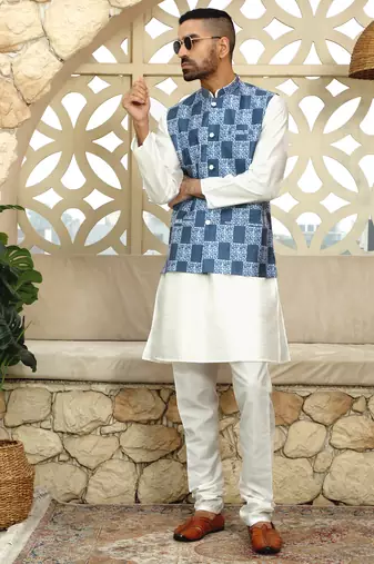 Silk blend solid cream kurta and churidar with blue printed nehru jacket