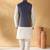 Silk blend cream kurta and churidar with jacquard geometric blue nehru jacket