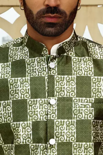 Silk blend solid cream kurta and churidar with green printed nehru jacket