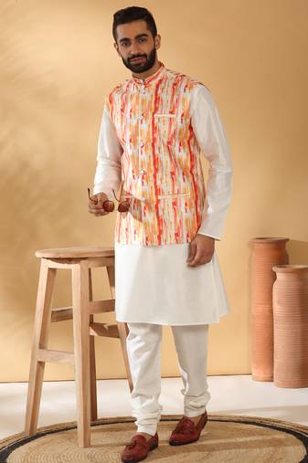 Silk blend cream kurta and churidar with tie-dye orange nehru jacket