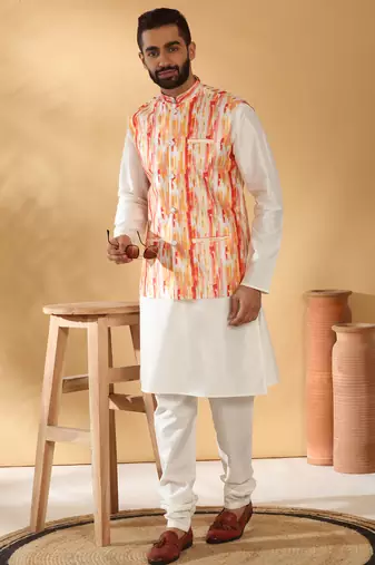 Silk blend cream kurta and churidar with tie-dye orange nehru jacket