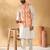 Silk blend cream kurta and churidar with tie-dye orange nehru jacket