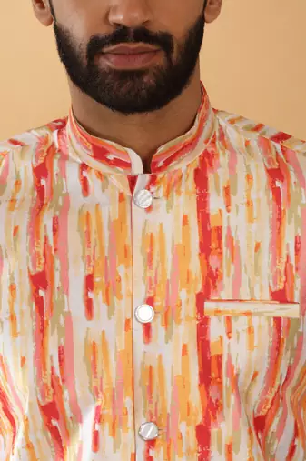 Silk blend cream kurta and churidar with tie-dye orange nehru jacket