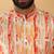 Silk blend cream kurta and churidar with tie-dye orange nehru jacket