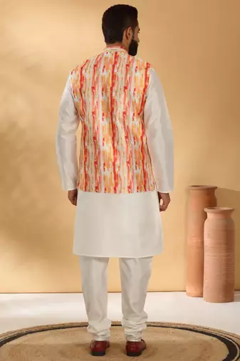 Silk blend cream kurta and churidar with tie-dye orange nehru jacket
