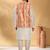 Silk blend cream kurta and churidar with tie-dye orange nehru jacket
