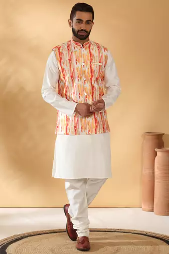 Silk blend cream kurta and churidar with tie-dye orange nehru jacket