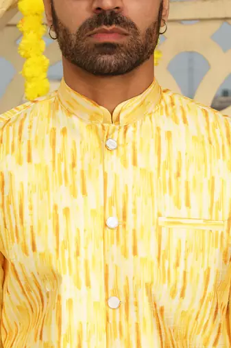 Silk blend solid yellow kurta and churidar with tie-dye yellow nehru jacket
